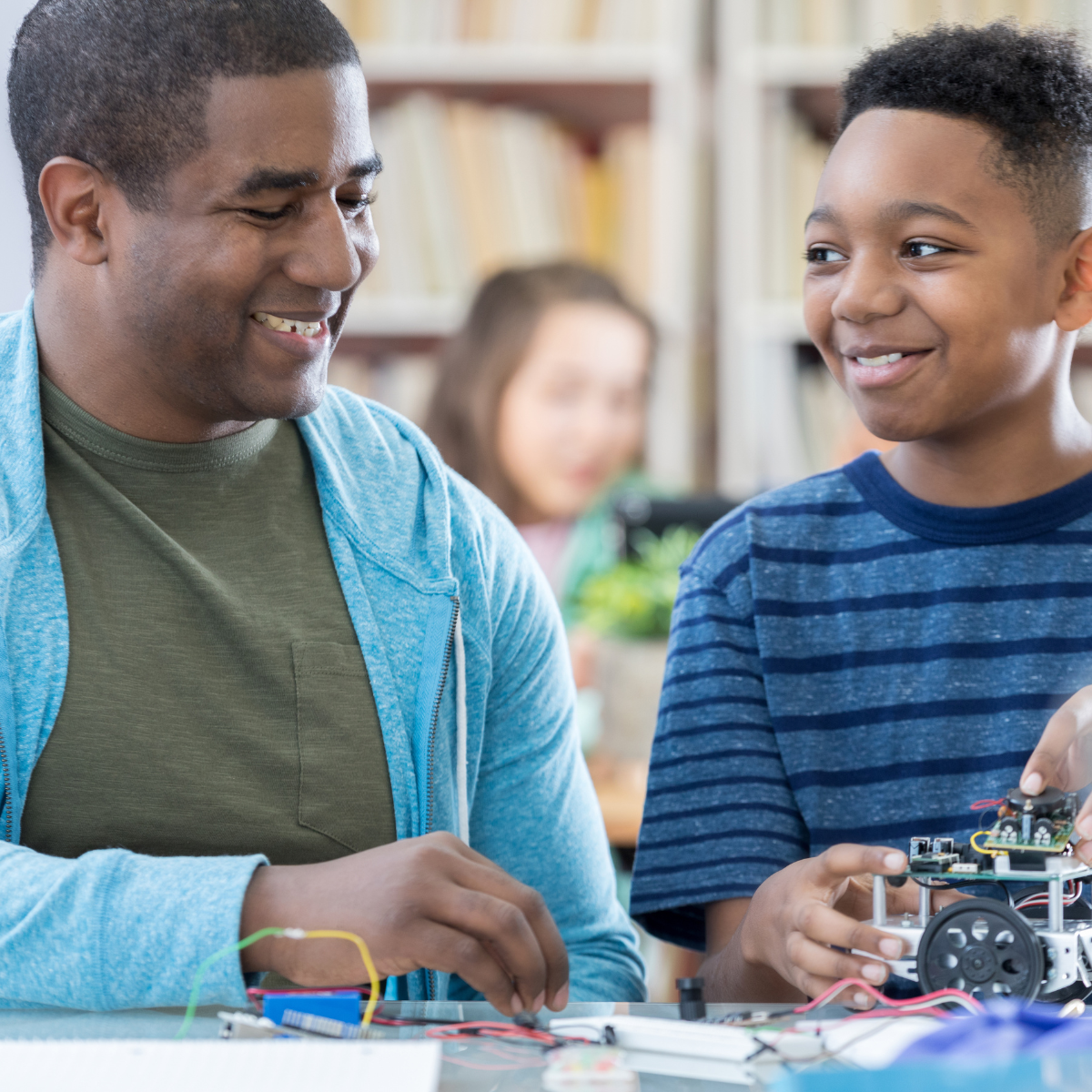father and son work on robot project